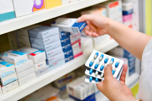 Pharmacist shelving medications